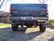 1963 Ford Fairlane - Rear view of a black Ford F-250 Super Duty pickup truck with large exhaust pipes and a chrome bumper.