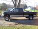 1963 Ford Fairlane - A black Ford F-250 pickup truck with a lifted suspension is parked outdoors on a gravel surface.