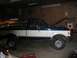 1989 Ford F-150 - This 1989 Ford F-150 pickup truck is shown in a garage with its hood raised, indicating potential mechanical work.