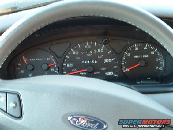 2001 Ford Taurus dashboard with speedometer, tachometer, and fuel gauge visible