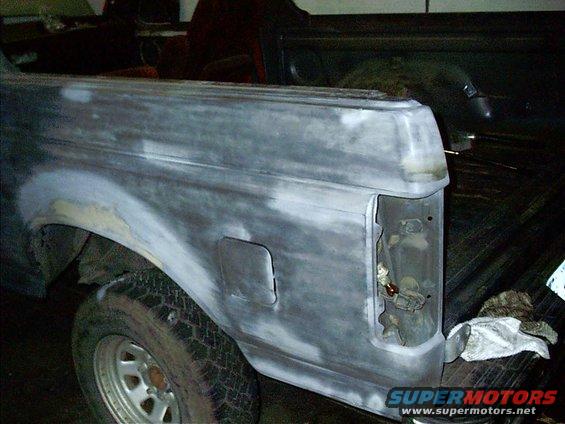 1987 Ford Bronco rear quarter panel with primer and body filler, tail light removed