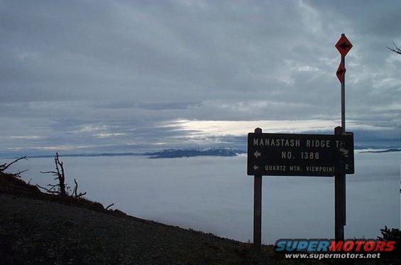 Signpost at Manastash Ridge with directions to Quartz Mtn. Viewpoint, set above a sea of clouds