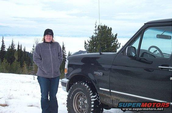 Black Ford Bronco with "BRONCO" badge, seen from the front-right in a snowy landscape