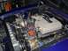 1965 Ford Mustang - Close-up of a V8 engine in a vehicle's engine bay, custom modifications.