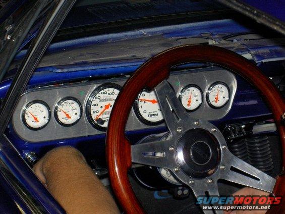 1965 Ford Mustang interior with wood steering wheel and custom gauges