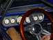 1965 Ford Mustang - Custom gauges and a wood-rimmed steering wheel are visible inside this 1965 Ford Mustang.