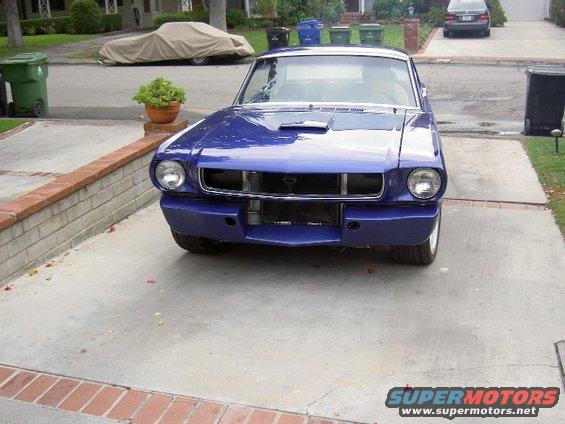 Blue 1965 Ford Mustang coupe parked in driveway