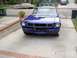 1965 Ford Mustang - Front view of a blue 1965 Ford Mustang coupe in a residential driveway.