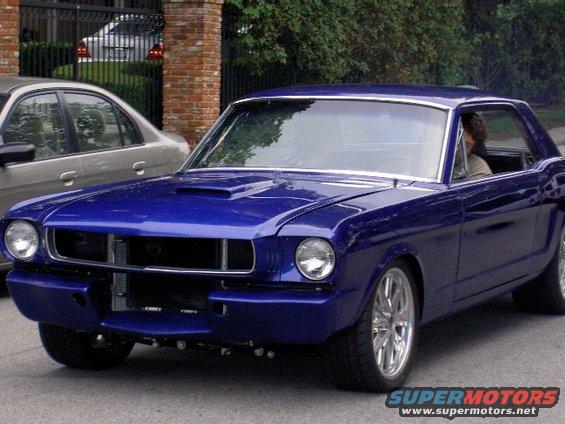 Blue 1965 Ford Mustang coupe with hood scoop and custom wheels