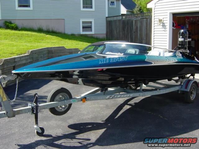 Blue and black speed boat on an EZ Loader trailer, with ME 3745Y registration visible