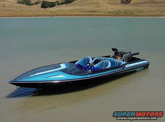 Speed boat with blue and black paint scheme, exposed engine, and two seats, floating on water