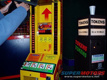 Yellow arcade game with digital score display and token dispenser