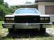 1985 Ford Crown Victoria LTD - Front view of a white 1985 Ford Crown Victoria LTD with a chrome bumper and black grille.