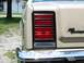 1985 Ford Crown Victoria LTD - Close-up of the rear taillight and 'Crown Victoria' badging on a tan sedan.