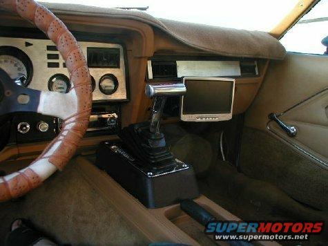 1978 Ford Mustang II interior with brown upholstery, aftermarket screen, and manual shifter