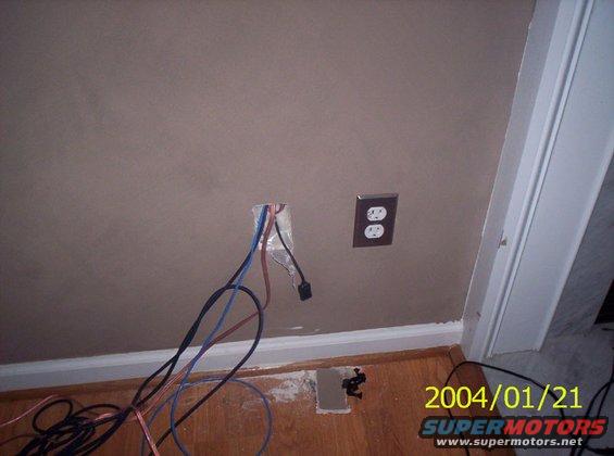 Exposed wiring and electrical outlets on a wall