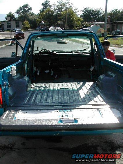 Teal pickup truck interior and bed, tailgate down
