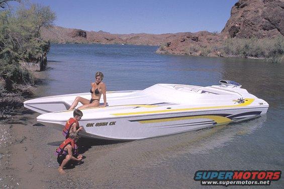 White and yellow speed boat with people on beach