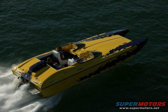 Yellow speed boat with black flame decals moving through dark water