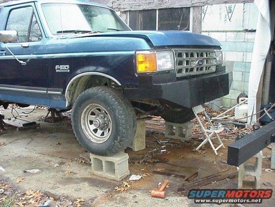 1987-1991 Ford F-series truck front end with custom bumper, raised on cinder blocks