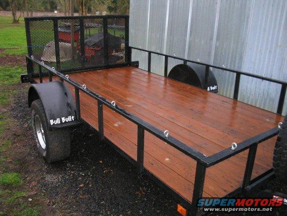 Utility trailer with wooden deck and metal railings