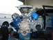 1985 Ford Crown Victoria LTD - Engine assembly in a garage, with parts of a white truck and a light blue car visible.