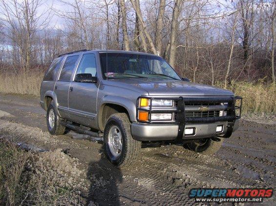 Gray SUV with bull bar on dirt road, 1995 model year