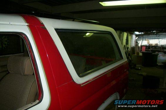 Red and white SUV side view, showing interior seat and roof rack