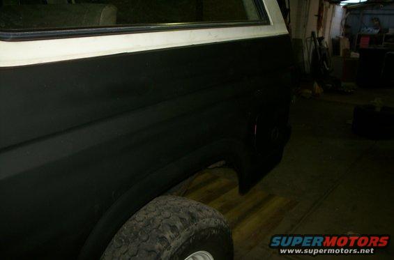 1981 Ford Bronco rear quarter panel and tire, painted black with white trim
