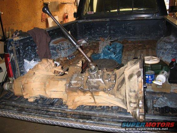 Transmission with shifter assembly removed and placed in the bed of a pickup truck