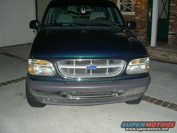 Front view of a dark green Ford Explorer with a silver grille and gray bumper