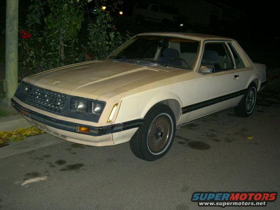 1982 Ford Mustang coupe, tan exterior, black grille, chrome trim, 3q front view