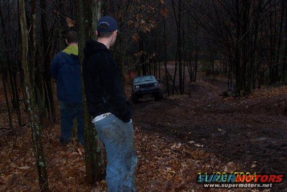 Dark Jeep Cherokee XJ on muddy trail