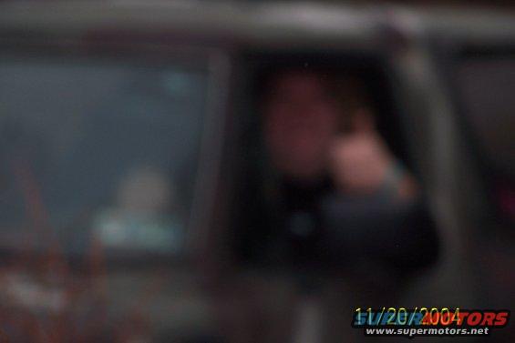 Blurry interior view of a vehicle with a person visible through the window