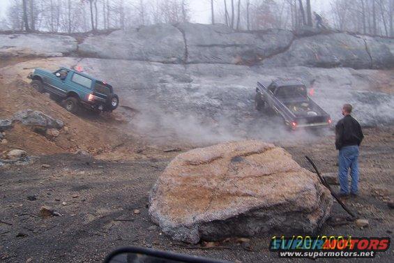 Teal 1979 Ford Bronco navigating rocky terrain