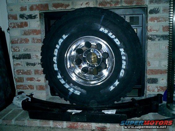 Mud King XT steel radial tire on chrome rim with leaf spring below