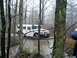 1979 Ford Bronco - A white Hummer H1 navigates a muddy path through a dense forest on an overcast day.
