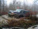 1979 Ford Bronco - SUV is stuck in a muddy trail surrounded by trees and brush.