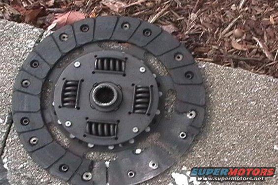 Clutch disc and pressure plate assembly on concrete and mulch