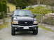 2003 Ford Ranger - Front view of a black 2003 Ford Ranger pickup truck parked outdoors.