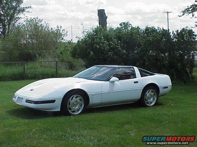 White 1994 Chevrolet Corvette parked on grass, side view