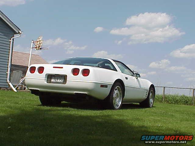 White 1994 Chevrolet Corvette parked on grass, rear view. License plate reads FKY 754