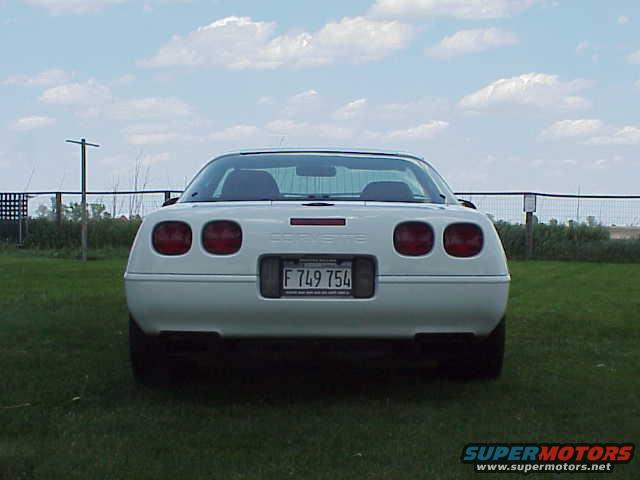 Rear view of a white 1994 Chevrolet Corvette with license plate F 749 754 parked on grass