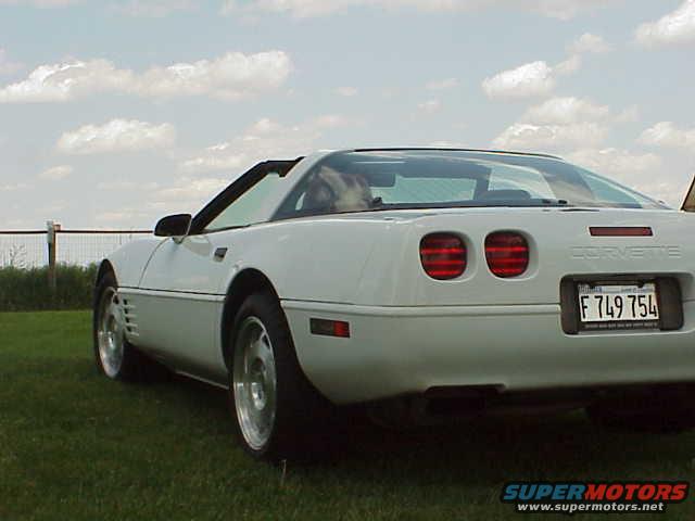 White 1994 Chevrolet Corvette with a removable roof panel, viewed from the rear quarter