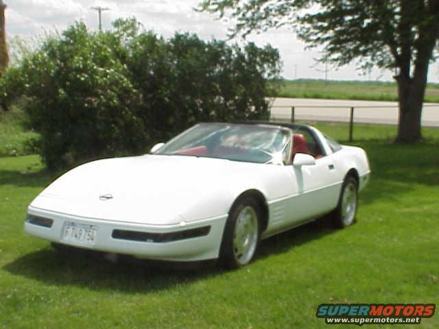 1994 Chevrolet Corvette convertible parked on grass, front 3/4 view. License plate F749TS4