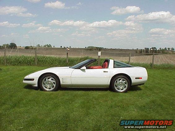 1994 Chevrolet Corvette, white exterior, red interior, parked on grass