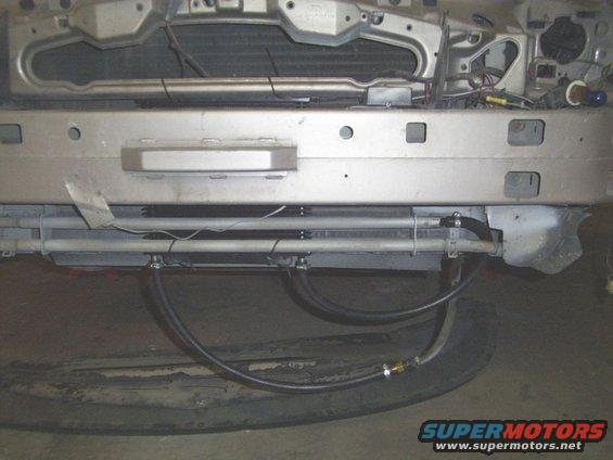 1998 Mercury Sable front bumper, grille, and radiator assembly with visible hoses and wiring