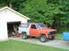 1981 Ford Bronco - This 1980 Ford Bronco, with its front end painted orange and the rear in gray, is parked outside a garage with its doors ajar.
