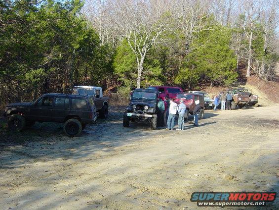 Group of off-road vehicles gathered on a dirt path