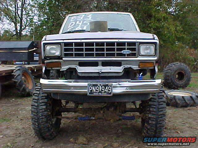 Front view of a lifted 1987 Ford Ranger with large off-road tires and a hood scoop
